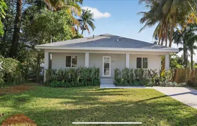 a white house with palm trees in a yard at New 3BR in Central Miami Location for Family & Groups in Miami