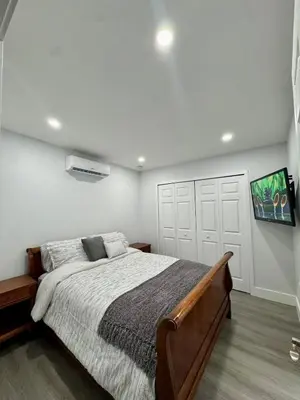 a bedroom with a large bed and a tv at Elegant Miami South Stay! in Cutler Bay