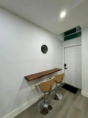 a room with two chairs and a table on a wall at Elegant Miami South Stay! in Cutler Bay