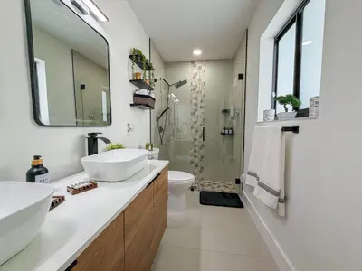 a bathroom with two sinks and a shower at King Comfort Suite Kitchen Wi-Fi Parking in Pembroke Pines