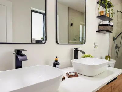 a bathroom with a large white sink and mirrors at King Comfort Suite Kitchen Wi-Fi Parking in Pembroke Pines