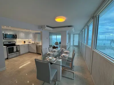 a dining room and kitchen with a table and chairs at Beachfront two story apartment in Miami Beach