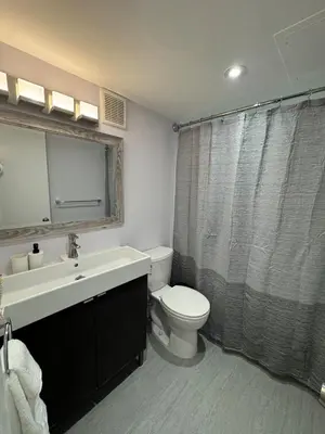 a bathroom with a white toilet and a sink at Beachfront two story apartment in Miami Beach