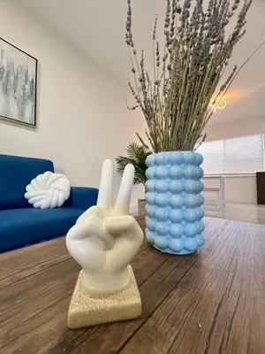 a living room with a blue vase and a white statue at 20 OFF BLUE WAVE 10min Beach and Airport in Fort Lauderdale
