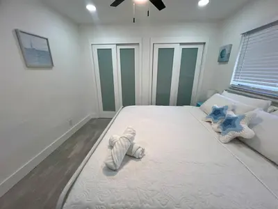a bedroom with a large bed with two stuffed animals on it at 20 OFF BLUE WAVE 10min Beach and Airport in Fort Lauderdale