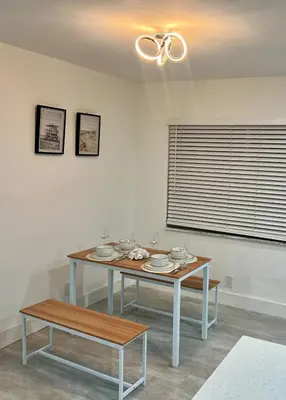 a dining room with a table and a window at 20 OFF BLUE WAVE 10min Beach and Airport in Fort Lauderdale