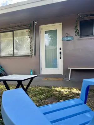 a table and a bench in front of a door at 20 OFF BLUE WAVE 10min Beach and Airport in Fort Lauderdale
