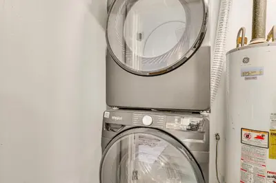 a washer and a washing machine in a room at 3 Mi to Port Everglades Modern Getaway with Yard in Dania Beach