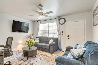 a living room with a couch and a tv at 3 Mi to Port Everglades Modern Getaway with Yard in Dania Beach