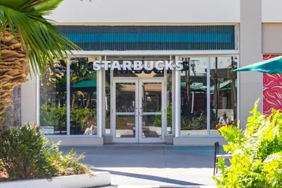 a starbucks sign on the front of a building at Bluebird Suites at The Apex Miami in Miami Beach