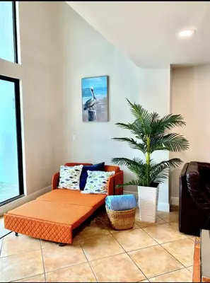 a living room with a couch and a table at Miami Beach-Front with Amazing Pool in Miami Beach