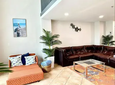 a living room with a leather couch and a coffee table at Miami Beach-Front with Amazing Pool in Miami Beach