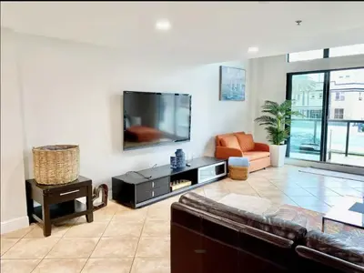 a living room with a large flat screen tv at Miami Beach-Front with Amazing Pool in Miami Beach
