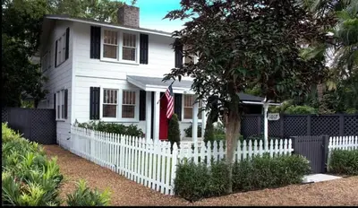a white picket fence in front of a white house at Historic Sailboat Bend Home 5 Min to Las Olas 4 miles to the Beach in Fort Lauderdale