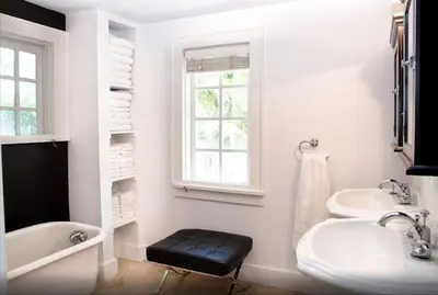 a bathroom with two sinks and a tub and a window at Historic Sailboat Bend Home 5 Min to Las Olas 4 miles to the Beach in Fort Lauderdale