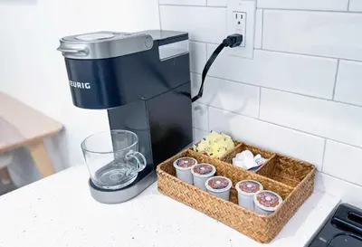 a coffee maker and a basket of cupcakes on a counter at The Hideaway - Wilton Manors in Fort Lauderdale