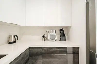 a kitchen with white cabinets and a counter top at 4 BR home with private pool in Fort Lauderdale