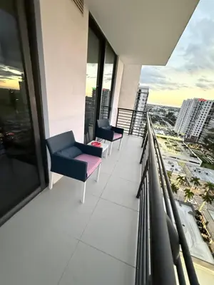 a balcony with chairs and a view of a city at Stylish Urban 5350 Park Doral in Miami