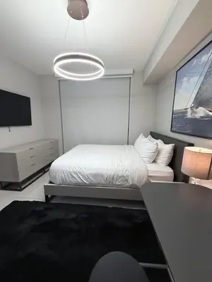 a bedroom with a bed and a flat screen tv at Stylish Urban 5350 Park Doral in Miami