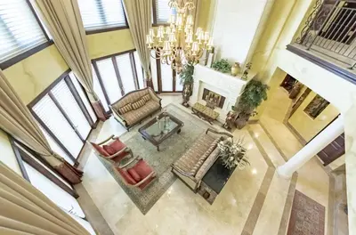 an overhead view of a living room with a chandelier at Serene 7000 SF Gated Luxury Waterfront Home in Fort Lauderdale