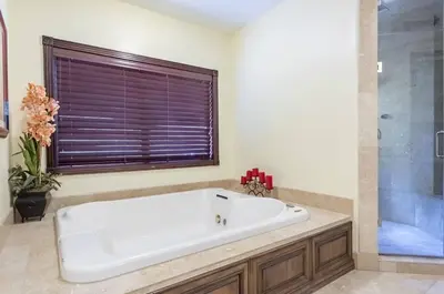 a large white tub in a bathroom with a window at Serene 7000 SF Gated Luxury Waterfront Home in Fort Lauderdale