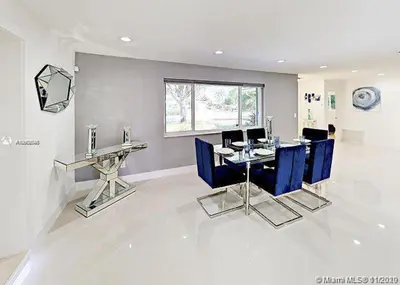 a dining room with blue chairs and a table at The Chill Crib in Fort Lauderdale