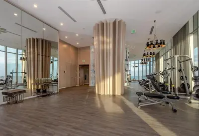 a gym with treadmills and exercise equipment in a building at Ocean Front Corner 2 Bedroom Low Floor in Hollywood