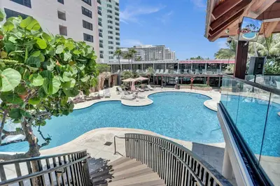 a large swimming pool in a building with a building at Bright 3BR 3BA Condo with Stunning Bay Views in Oceanfront Complex 820 in Miami Beach