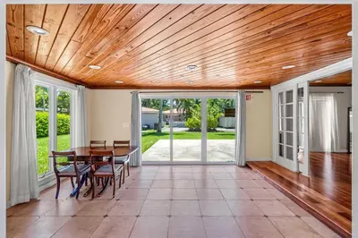 a dining room with a wooden ceiling and a table at Brazilian Style Getaway 2 Minutes to Beach in Hollywood