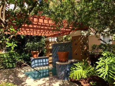 a backyard with a pergola and some plants at The Yacht Club at Aventura Miami 8304 in Aventura