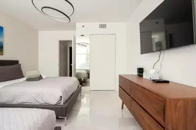 a bedroom with a bed and a dresser with a tv at The Yacht Club at Aventura Miami 8304 in Aventura