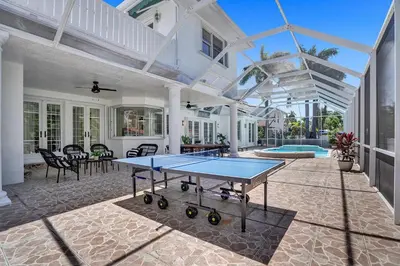a ping pong table on the back of a house at 6BR Elegant Hollywood Lakes Mansion with Private Pool & Spa in Hollywood