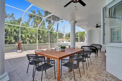 a dining room with a wooden table and chairs at 6BR Elegant Hollywood Lakes Mansion with Private Pool & Spa in Hollywood