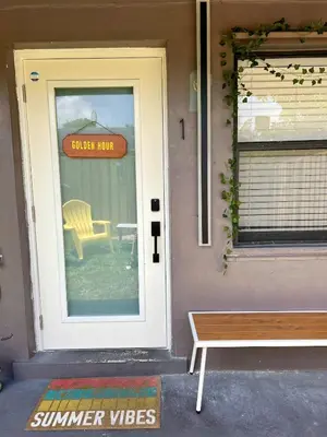 a front door of a house with a sign on the door at 20 OFF Golden Hour BBQ 10 MIN Beach Airport FL in Fort Lauderdale