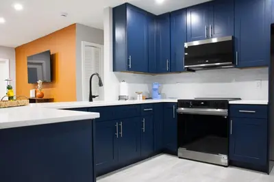 a kitchen with blue cabinets and a black oven at 20 OFF Golden Hour BBQ 10 MIN Beach Airport FL in Fort Lauderdale