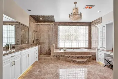 a large bathroom with a tub and a sink at 6BR Elegant Hollywood Lakes Mansion with Pool & Spa home in Hollywood