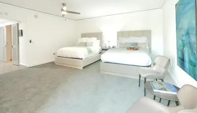 a bedroom with two beds and a couch at Luxury Studio at The Ritz-Carlton Key Biscayne in Miami