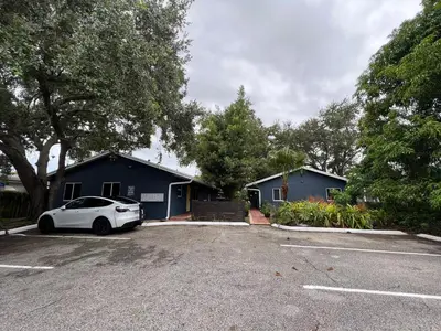 a car parked in a parking lot in front of a house at Modern 2 BR near shops, WD fast WiFI 2000mbps 10 min to beach Bliss 7 in Hollywood