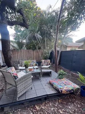 a patio with two chairs and a table and a tree at Modern 2 BR near shops, WD fast WiFI 2000mbps 10 min to beach Bliss 7 in Hollywood