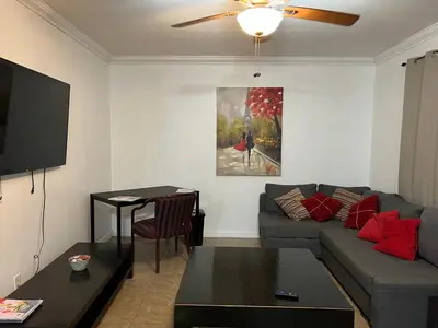 a living room with a couch and a table at Modern 2 BR near shops, WD fast WiFI 2000mbps 10 min to beach Bliss 7 in Hollywood