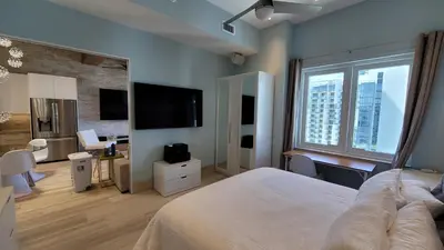 a bedroom with a bed and a desk and a television at South Beach Luxury 2 Bedroom Condo on the Ocean in Miami Beach