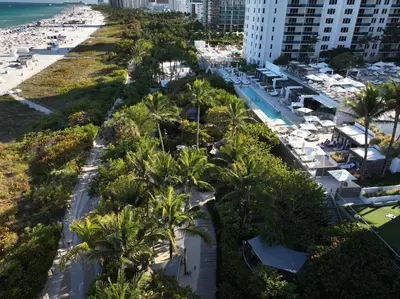 an aerial view of a beach with palm trees and buildings at South Beach Amazing Ocean View in Miami Beach