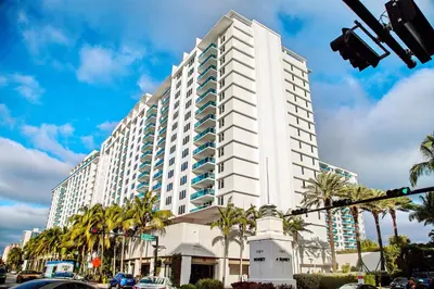 a large white building with palm trees in front of it at South Beach Amazing Ocean View in Miami Beach