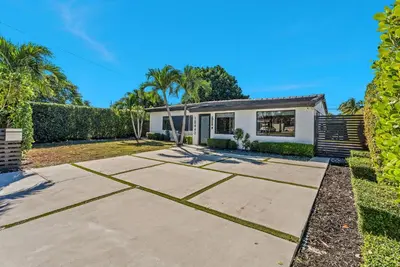 a home with a driveway in front of a house at Azure Coastal Breeze in North Miami Beach