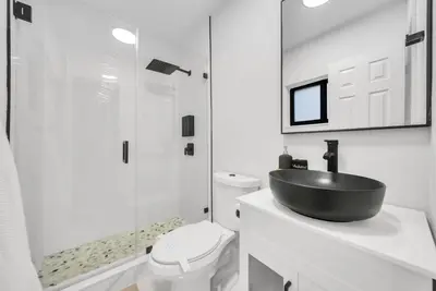 a bathroom with a sink and a toilet and a shower at Azure Coastal Breeze in North Miami Beach