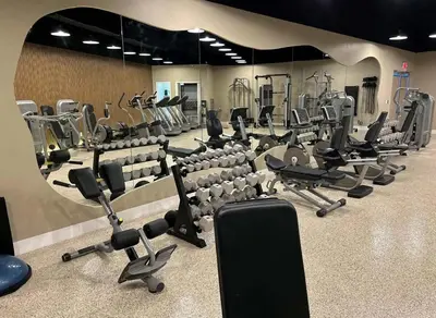 a gym with a lot of treadmills and chairs at A dreamed bay view studio at Castle Beach Club in Miami Beach