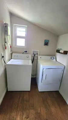 a kitchen with a white refrigerator and a window at LUSH TROPICAL STUDIO in FT LAUDEDALE'S HISTORICAL SAILBOAT BEND NEIGHBORHOOD in Fort Lauderdale