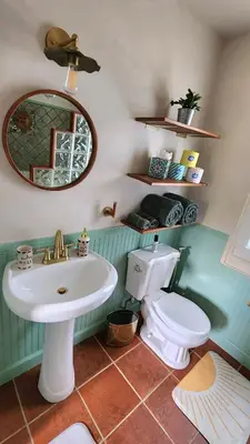 a bathroom with a sink and a toilet and a mirror at LUSH TROPICAL STUDIO in FT LAUDEDALE'S HISTORICAL SAILBOAT BEND NEIGHBORHOOD in Fort Lauderdale