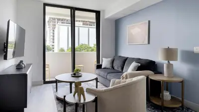 a living room with a couch and a table at Landing Chic 2BD Clubhouse Yoga Studio in North Miami