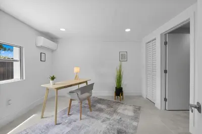 a white room with a desk and a chair at Villa Gabriel Modern, Family Home Just 15 minutes downtown Miami in Miami